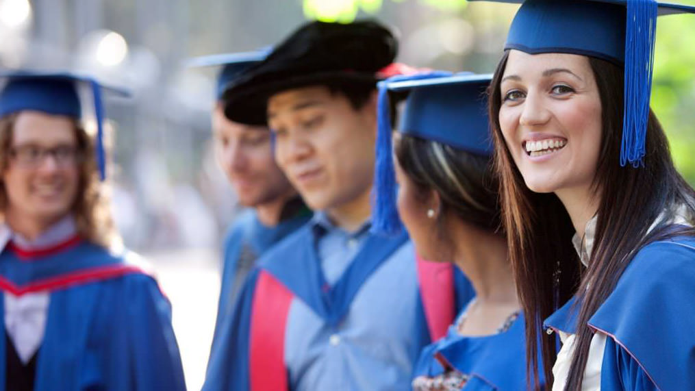 Students smiling at graduation